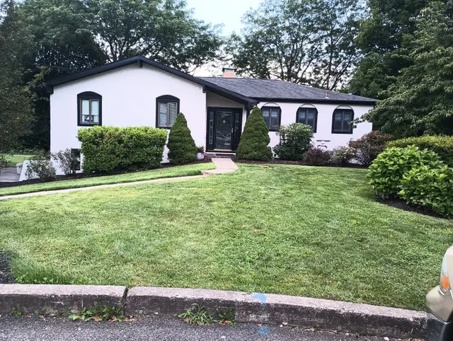 After: the same ranch in white, with black trim and window frames.