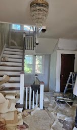 Staircase area drywall and plaster repair in progress - drywall repair and plaster restoration.