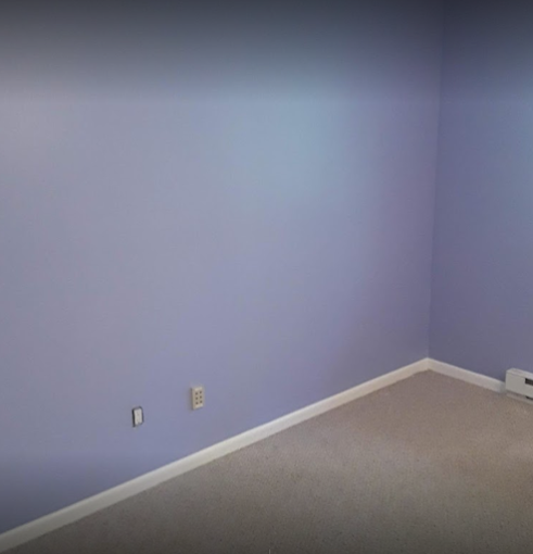 Smooth-finished drywall under soft lavender paint — flawless, even walls ready for a premium finish. Drywall & painting.